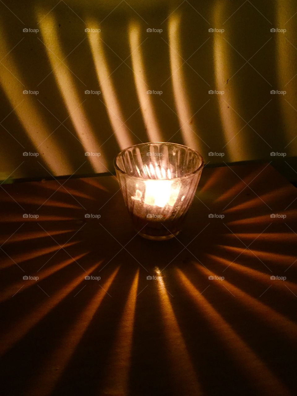 Look at how a single candle can both defy and define the darkness.