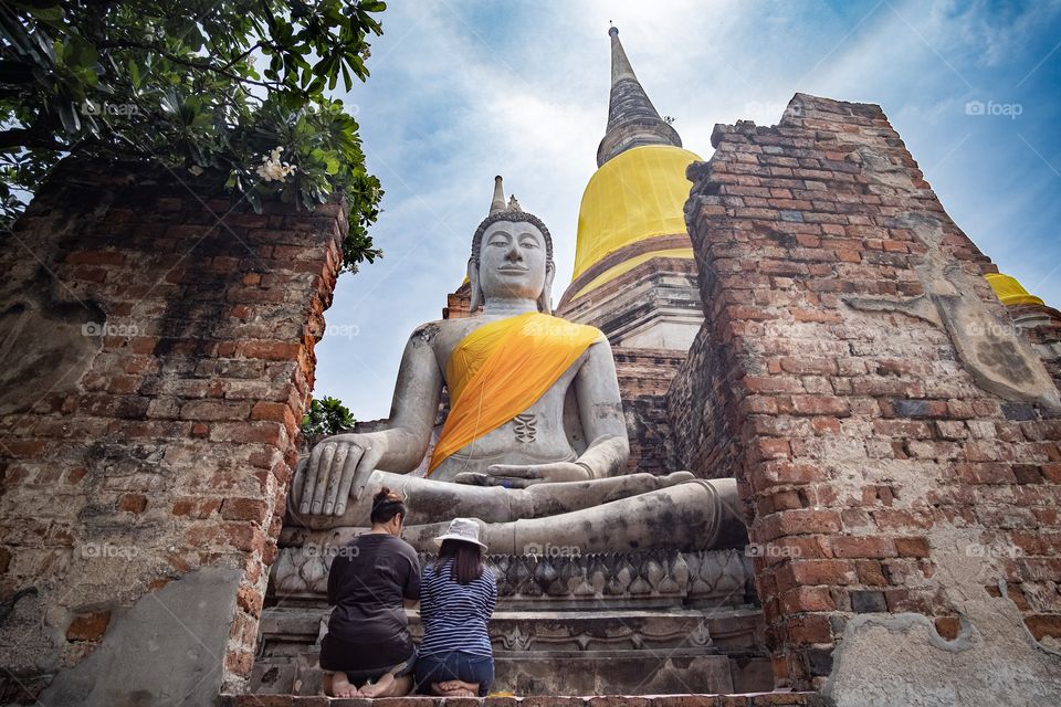 Tourists visit Wat Yai Chimongkol formerly named "Wat Pa Keaw" or "Wat Chao Thai" Located at Aytthaya Thailand. Highlights of the Temple is the big Pagoda is located on the East side of Ayutthaya.
