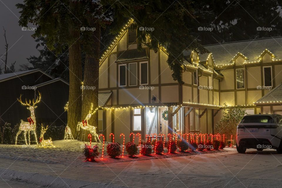 Big house decorated with yellow lights for Christmas 