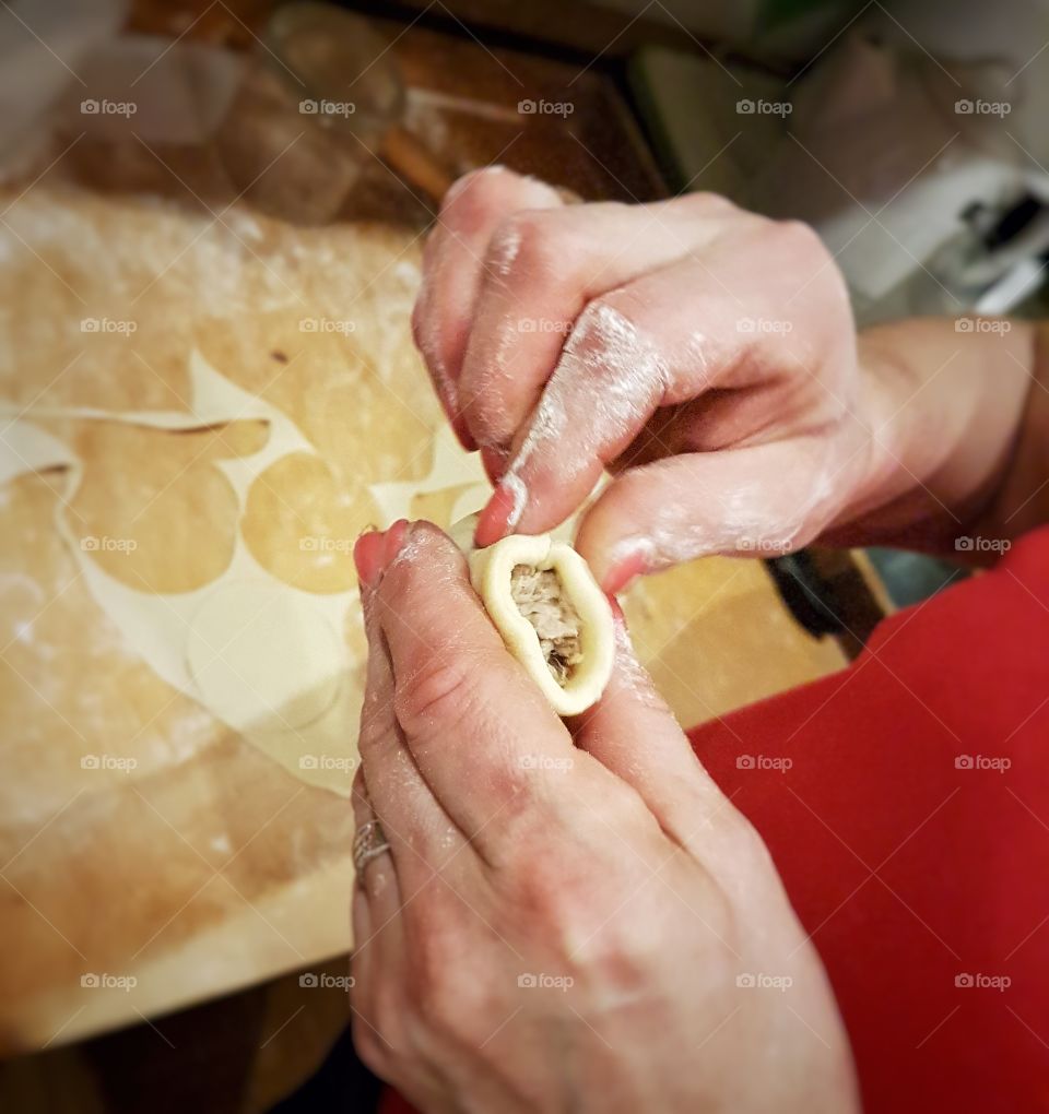 Close-up of person making piegori