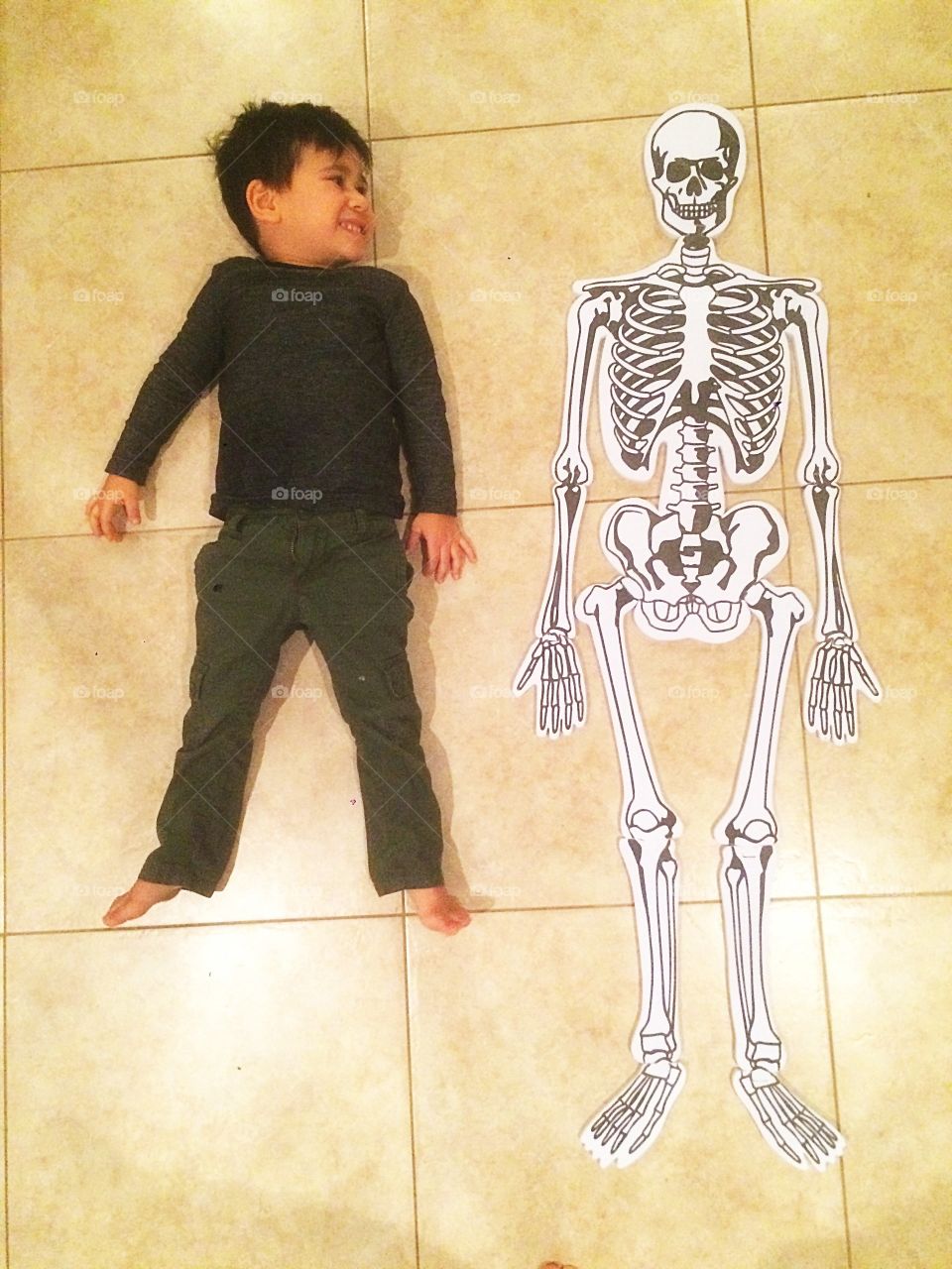 Boy lying with skull