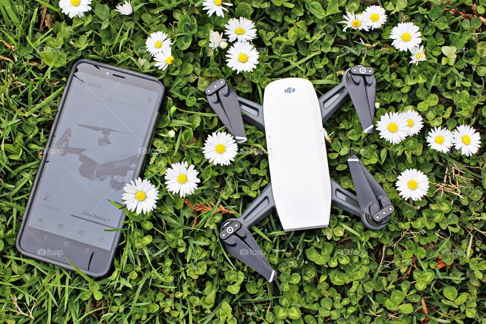 technology drone smartphone controller in a field of dandelions