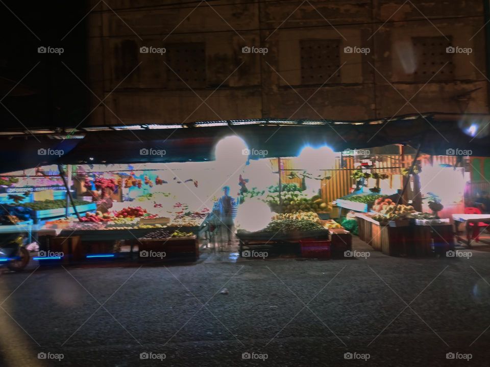 Night view of a traditional store by street. Long exposure, blured and defocused