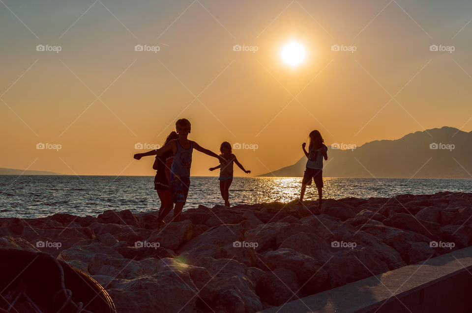 Children are walking on the beach of Bashka-Voda, Croatia