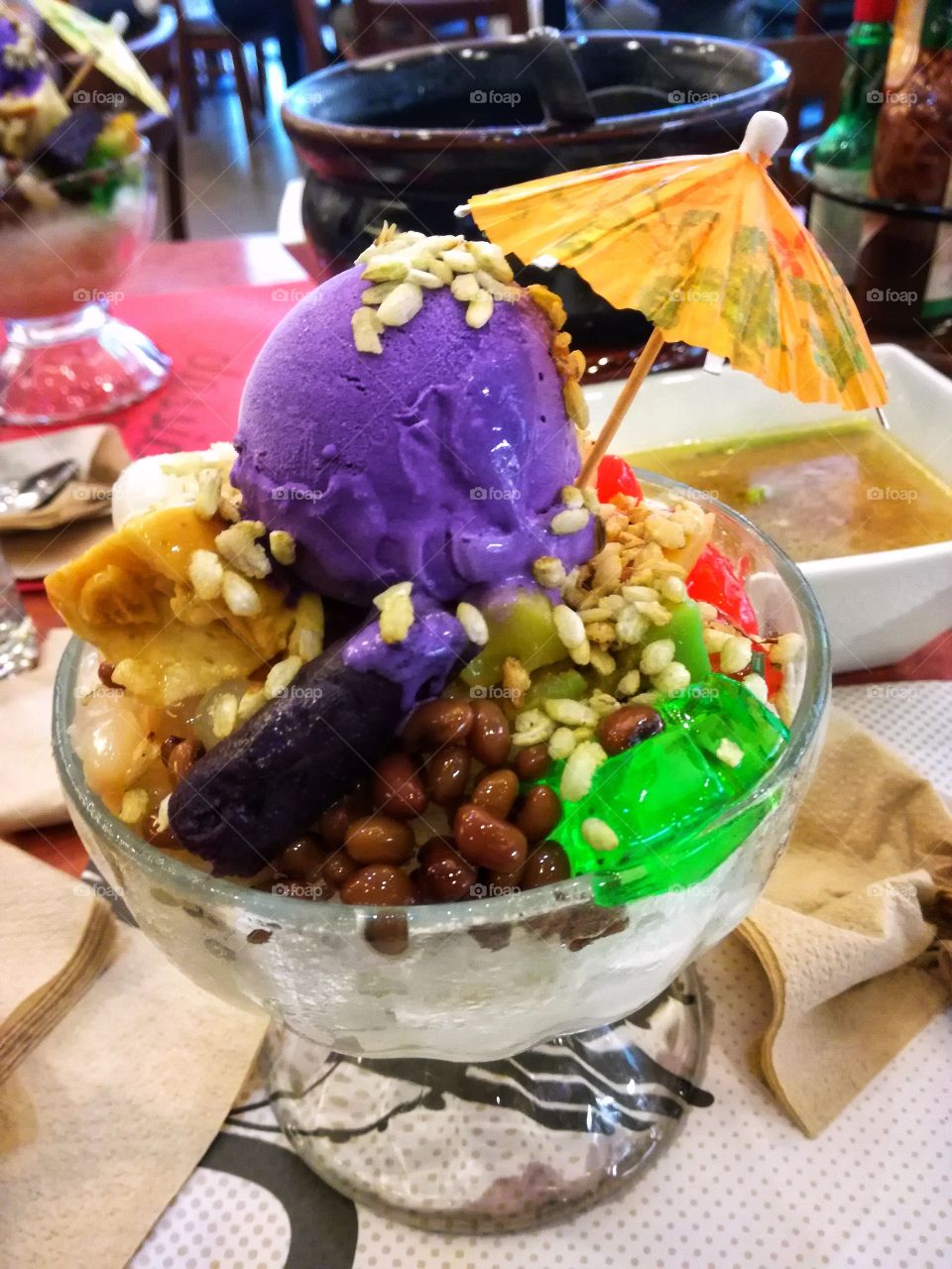Halo-halo is a popular Filipino cold dessert which is a concoction of crushed ice, evaporated milk and various ingredients and topped with a scoop of ice cream. 😋