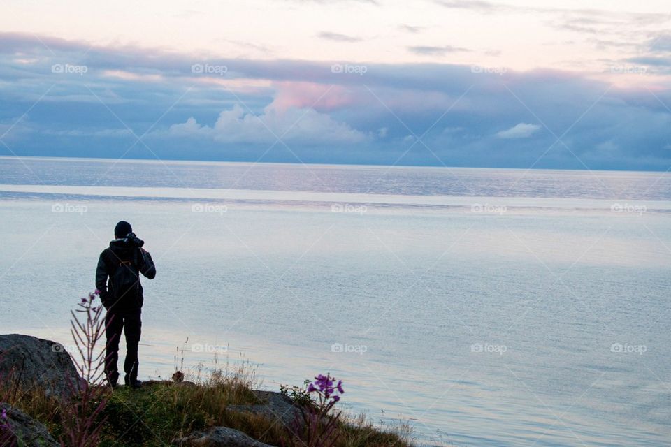 Man looking out over the ocean 