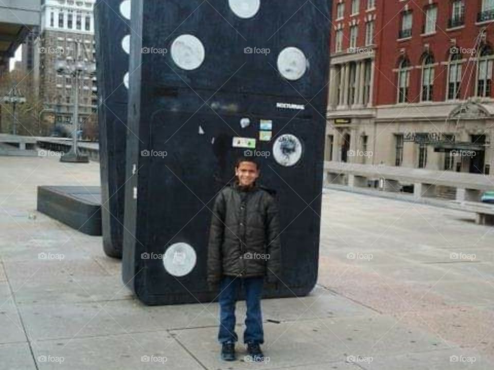 Kid and  big dominoes sculpture in downtown,  Philadelphia.
