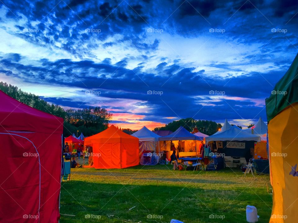 Colorful tents under a dramatic sky