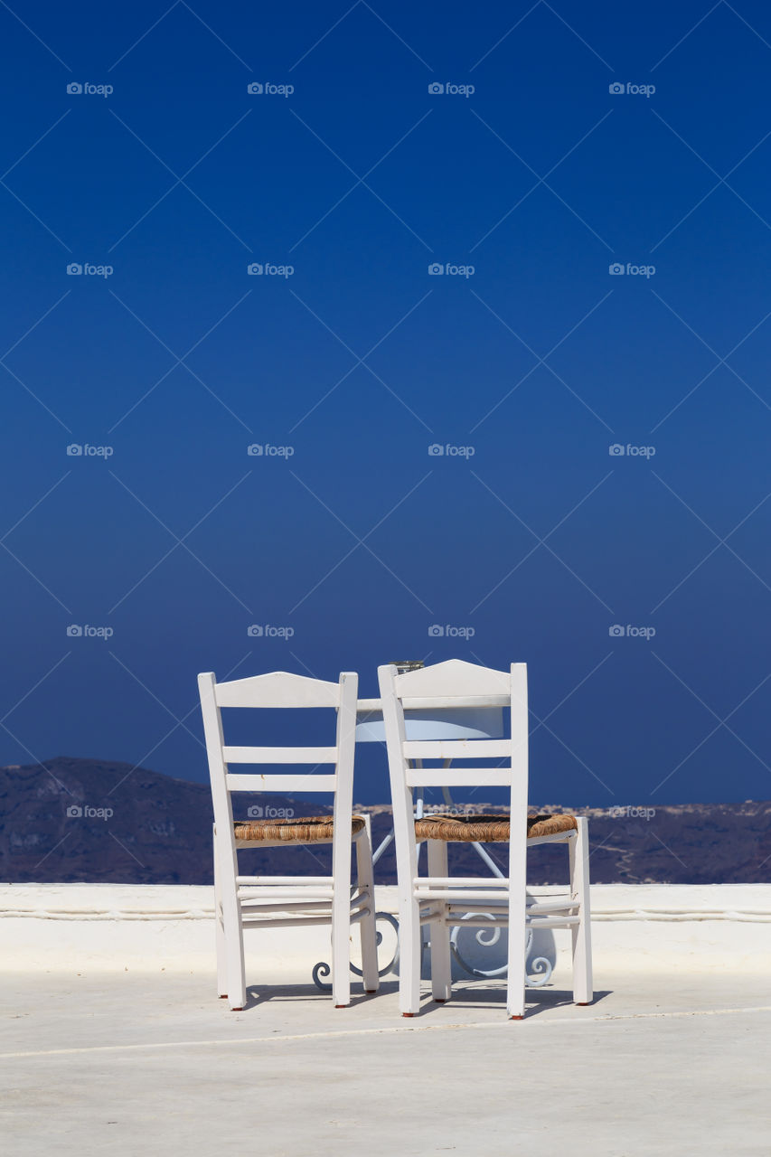 Coffee table in Santorini, Greece . Table and chairs with a view over the Caldera.