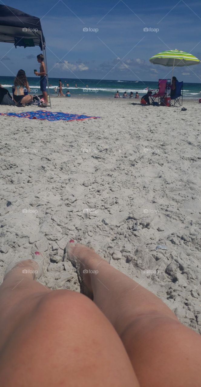 toes in the sand at the beach on a sunny day