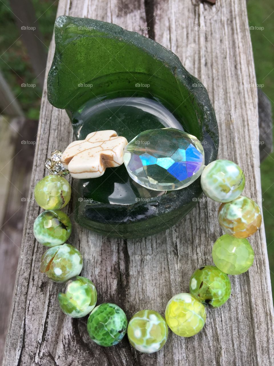 Green bracelet on glass