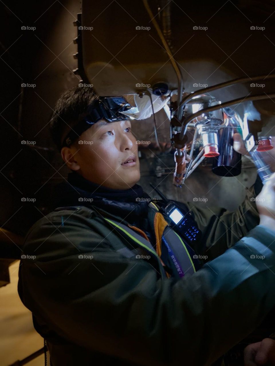 An aircraft maintenance mechanic fixing auxiliary power unit of Airbus A320