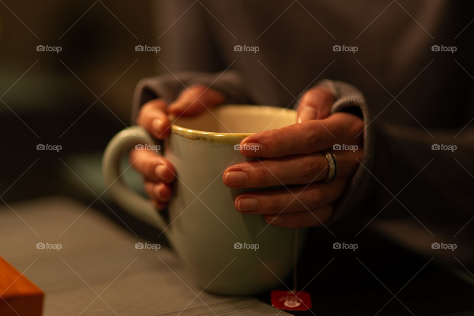cup of tea and hands in a beautiful light