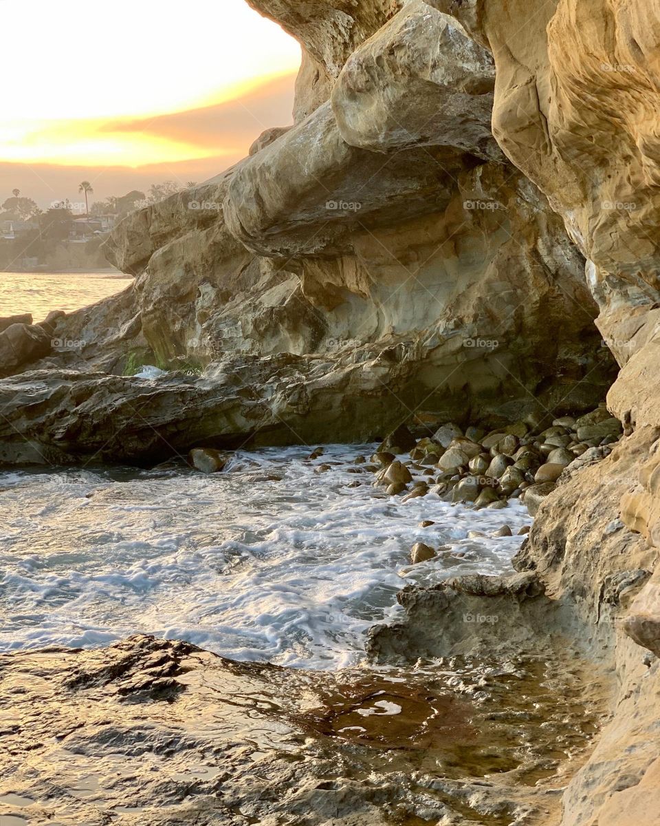 Ocean waves crashing into a rocky cave