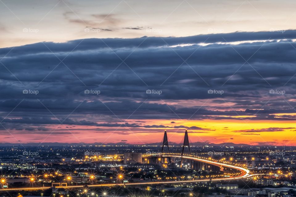 Vehicle light on the long road of the Bhumibol landmark bridge in front of twilight background in Bangkok Thailand