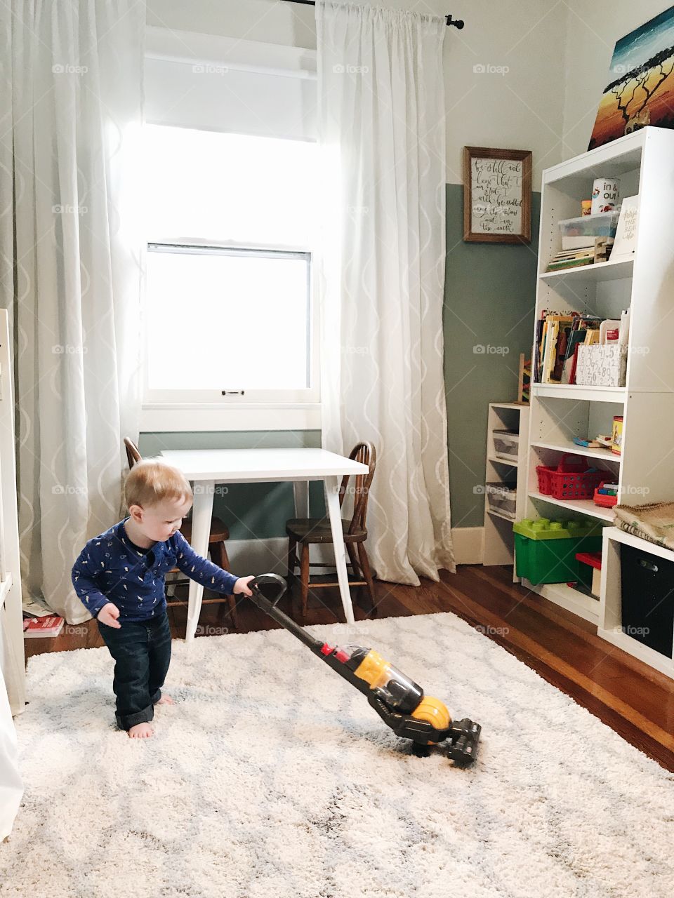 Child cleaning with Dyson vacuum 