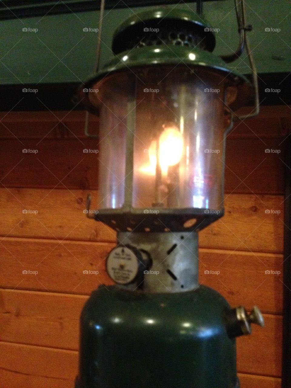 Look, it's an old, back in the day camping lantern on a table.