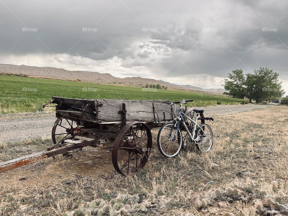 Lonely bike in a seemingly different era, between the high desert and green farmland.