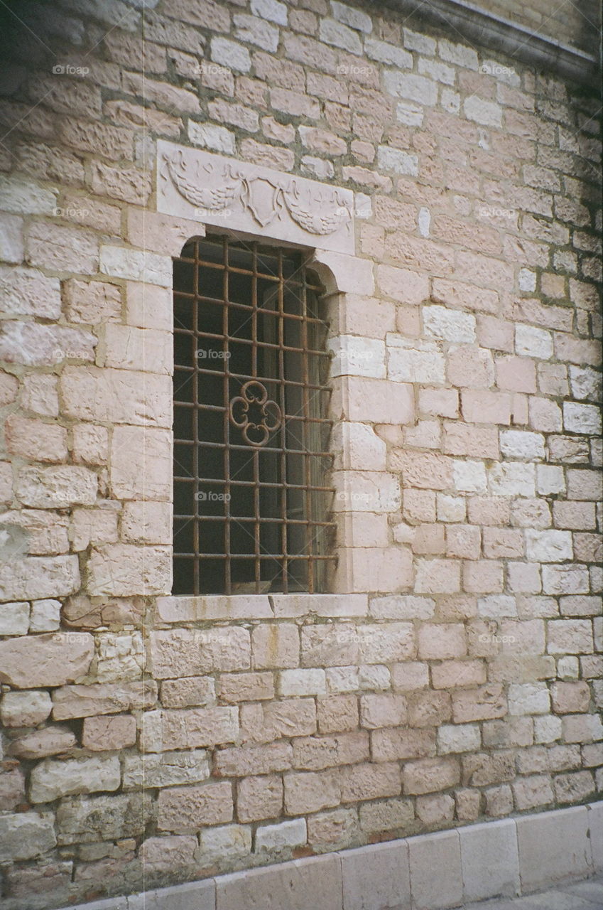 Iron Art Window Stone Wall