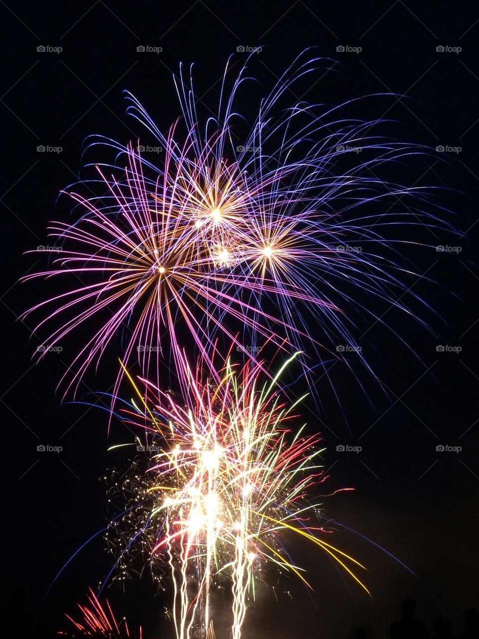 Multicolored firework celebrating the national day in France captured in long exposure.