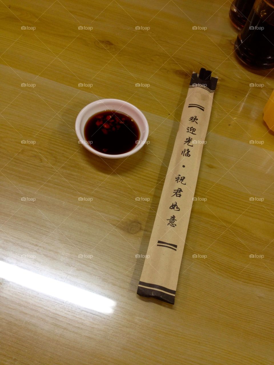 Soya sauce with sticks on a table