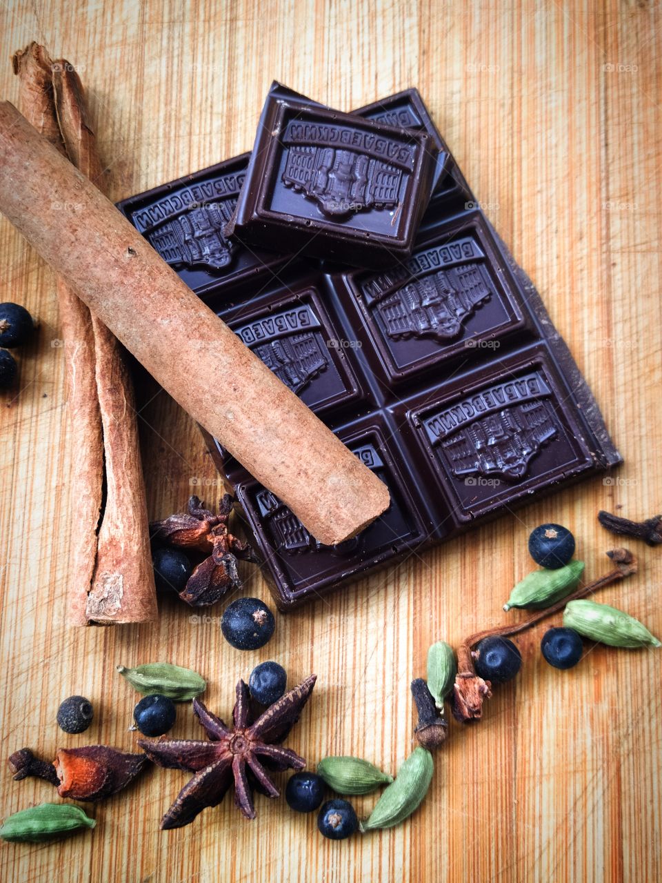 Dark chocolate bars and spices: cinnamon stick, juniper a, anise, mustard seeds