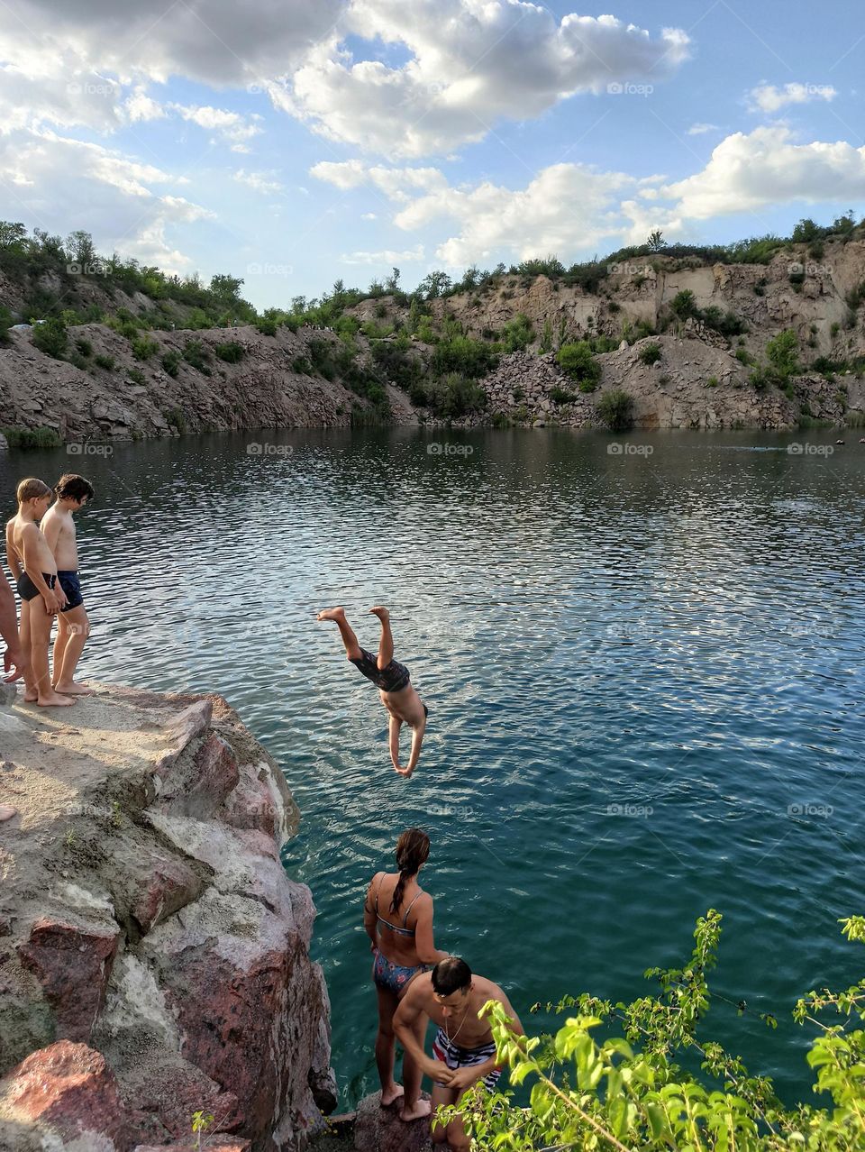 jump into the water from a cliff at a radon lake. Radon lake. Ukraine.