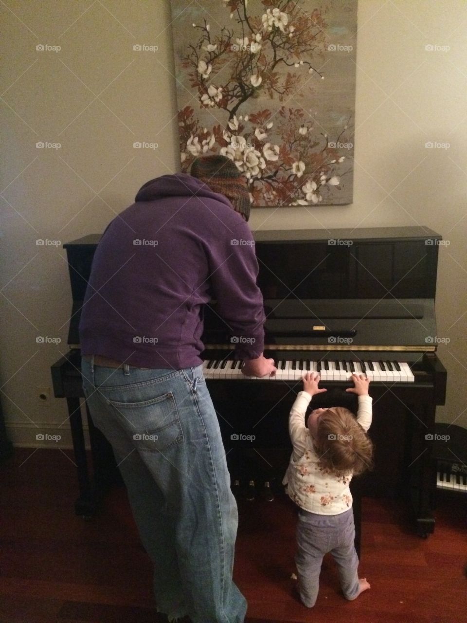 Man with toddler playing piano