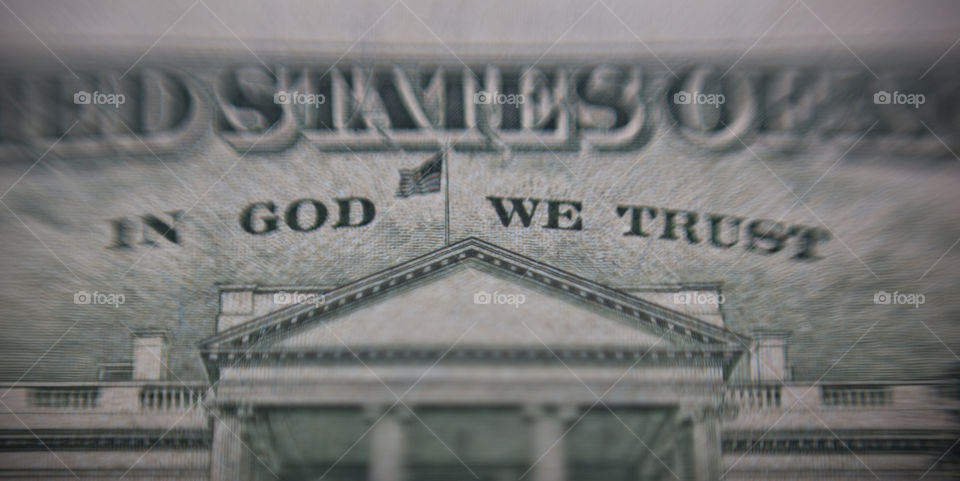 close of an American us dollar bank note mentioned in God we trust
