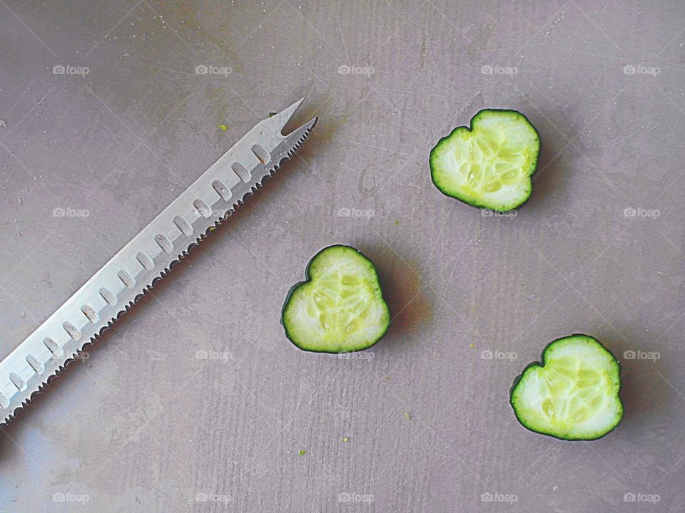 Sliced cucumber hearts with a knife