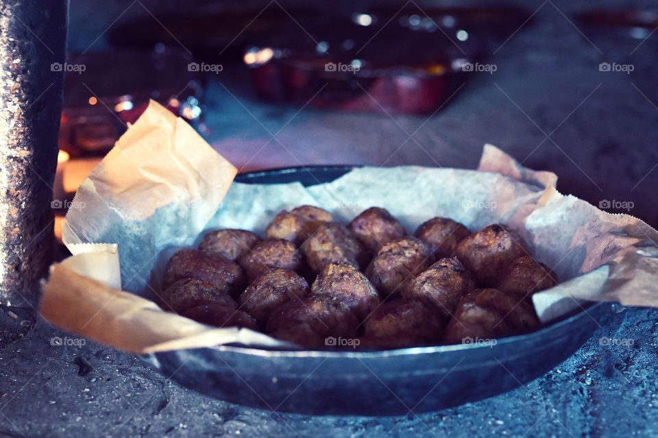 Meatballs cooked in a wood oven