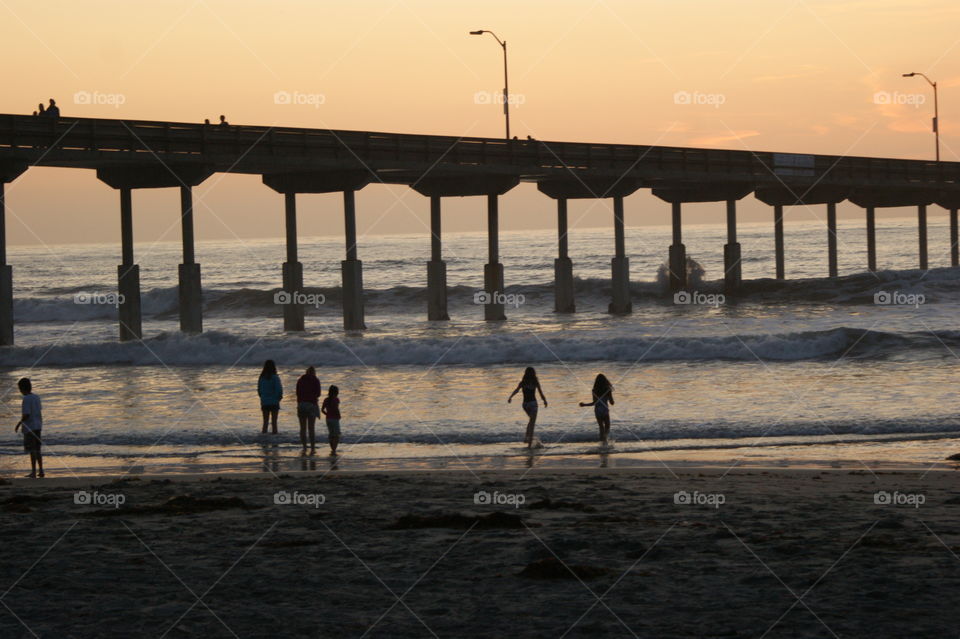 Family at dusk under pier - San Diego CA