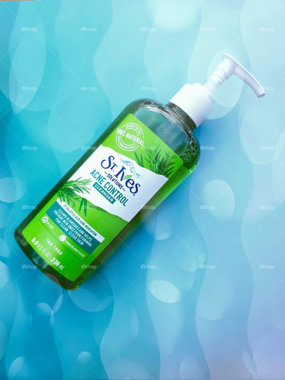 St. Ives Acne control cleanser on a fun summer vibes bubbly wavey aqua colored background.