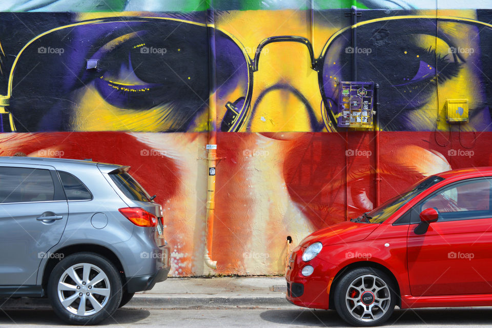 Wynwood Florida is a city of graffiti walls, this photo is cars parked on one of the streets. 