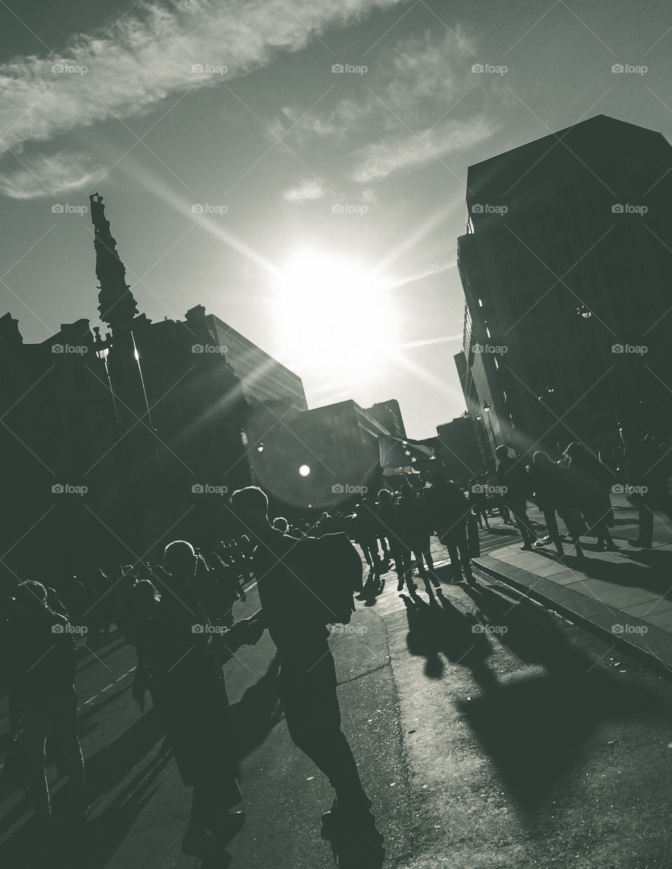 Long shadows are cast on a busy street in London as the sun starts going down