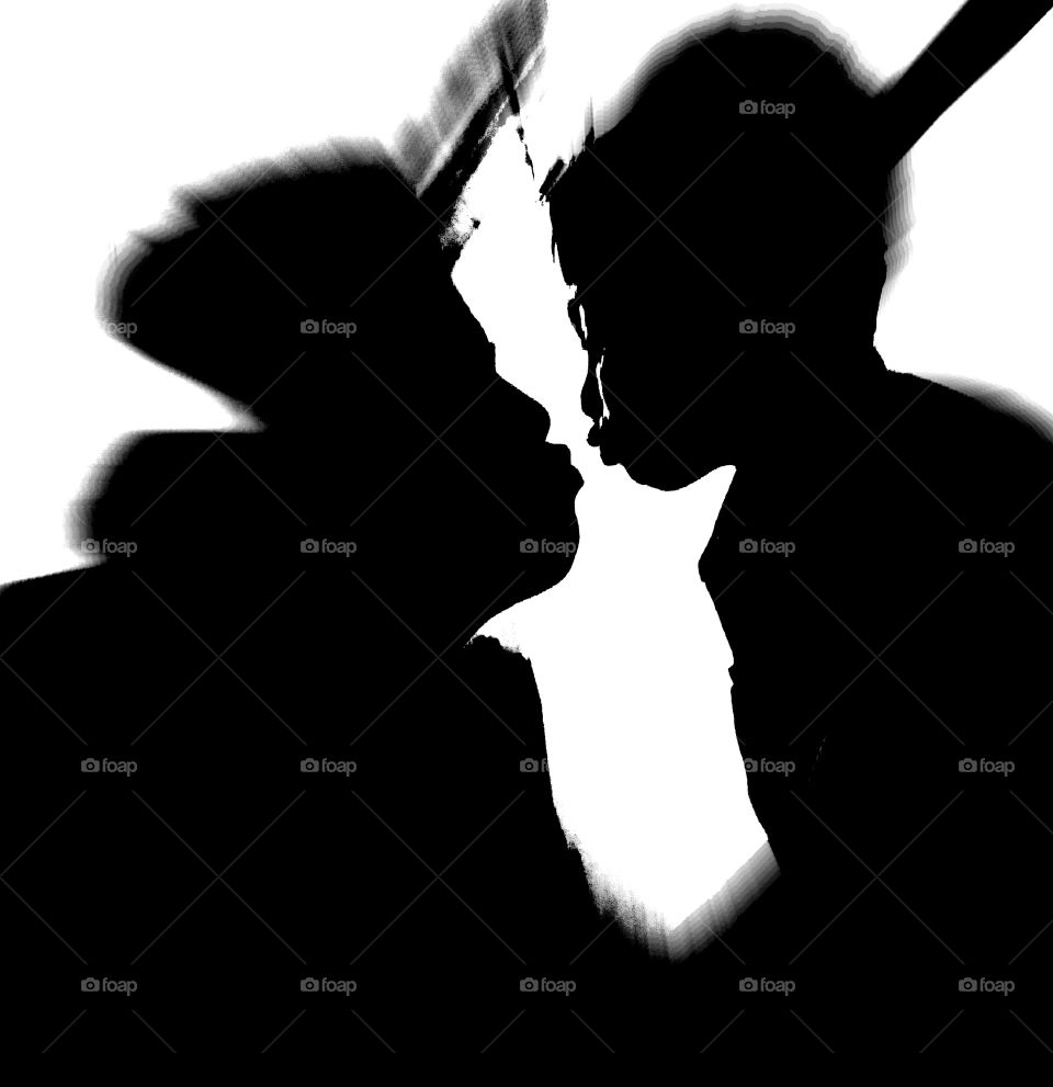 Silhouette of mother kissing her son.Black & white potrait.