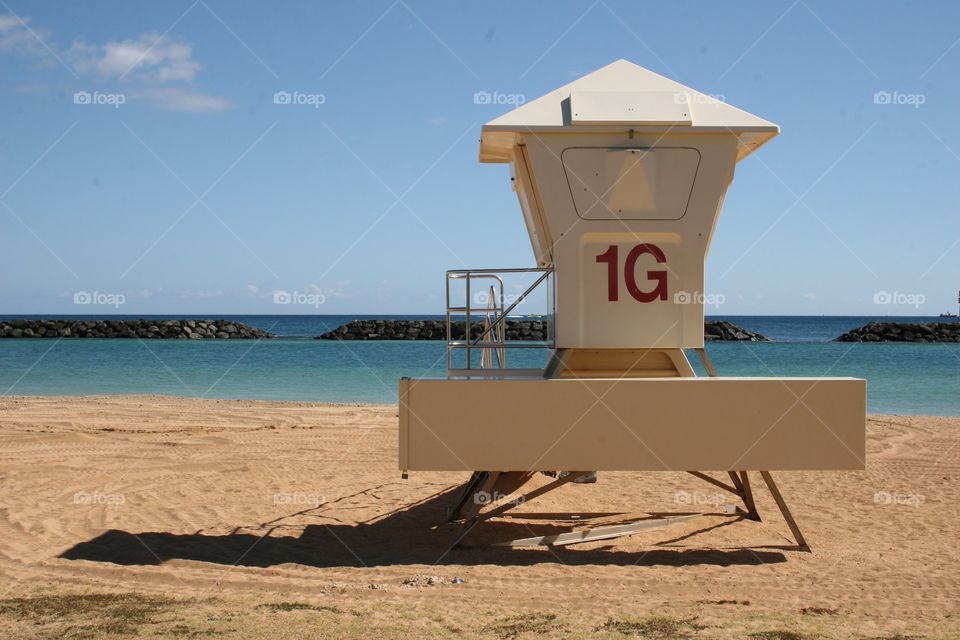 Lifeguard Station on Beach. A white lifeguard tower at Ala Moana Beach Park on Oahu, Hawaii.