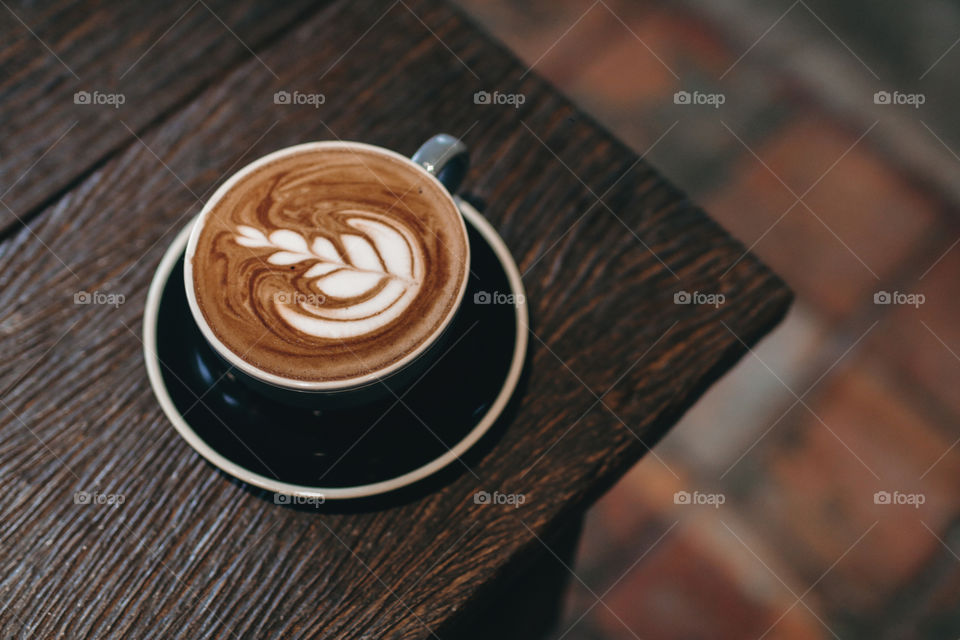 Hot coffee latte on wooden table 