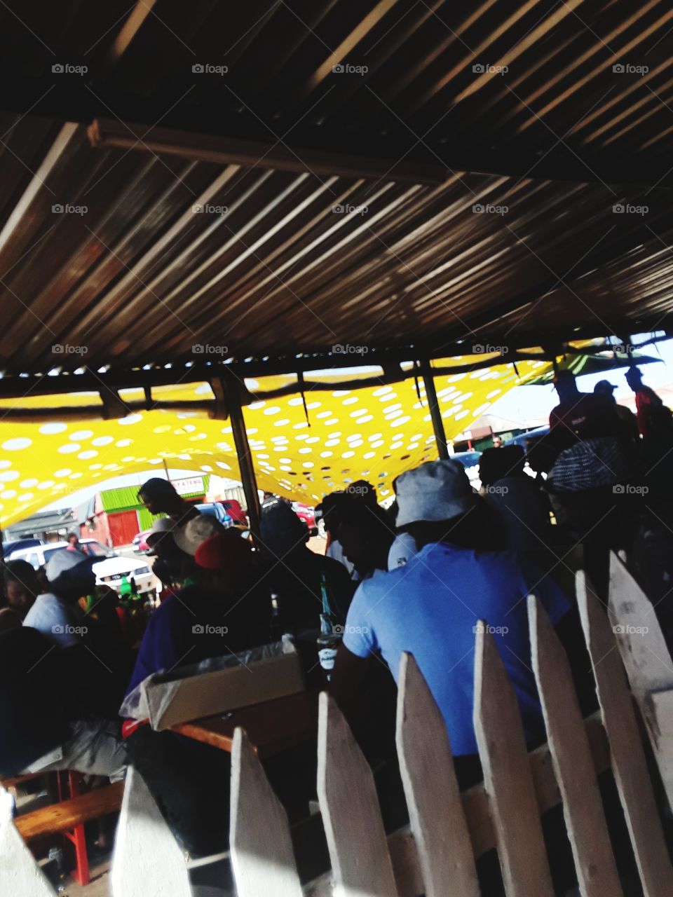 people under the shade of a shelter.