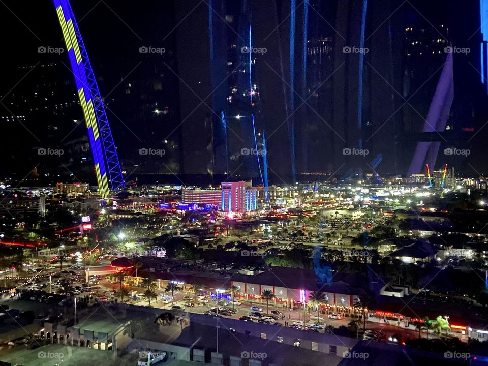 A nighttime view of colorful city lights from above