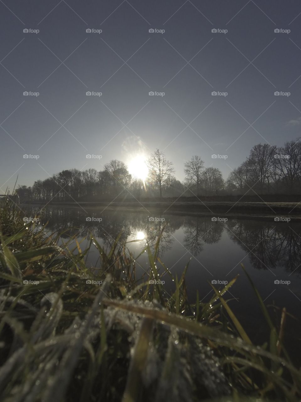 Countryside sunrise showing the colorful sky over the frozen grass