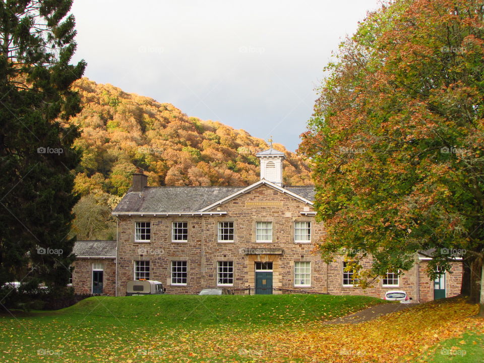 autumn colours in front of and behind the lovely old stone building