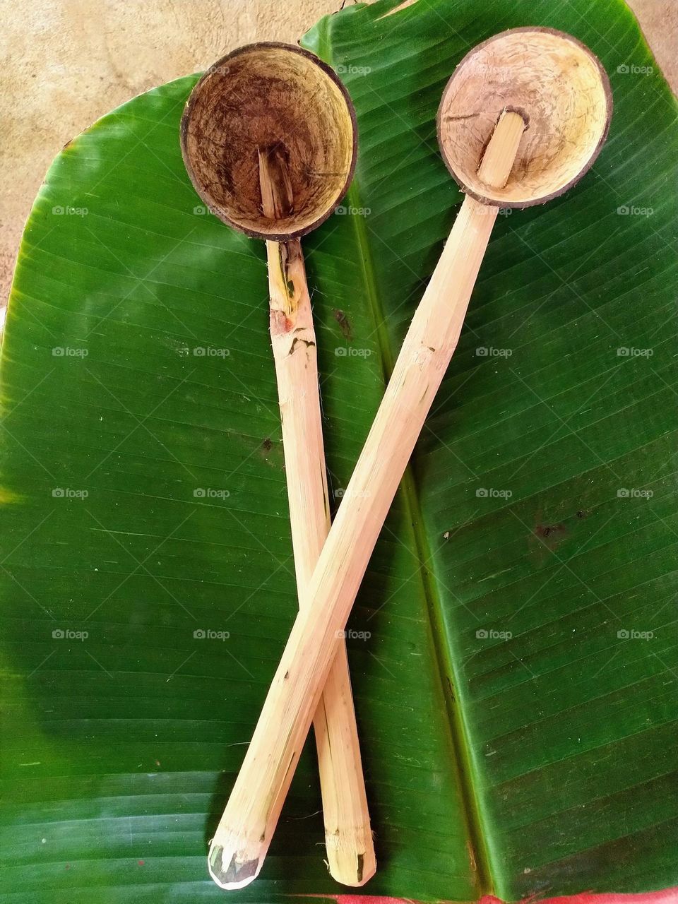 Coconut shell spoons with banana leaf background