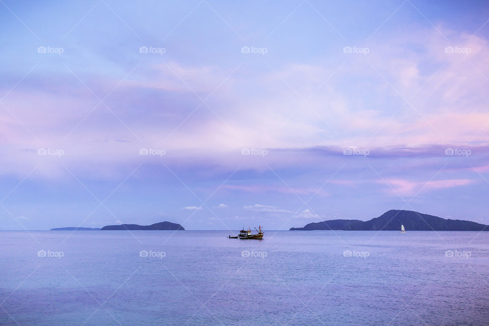 Landscape tropical sea in twilight with boat