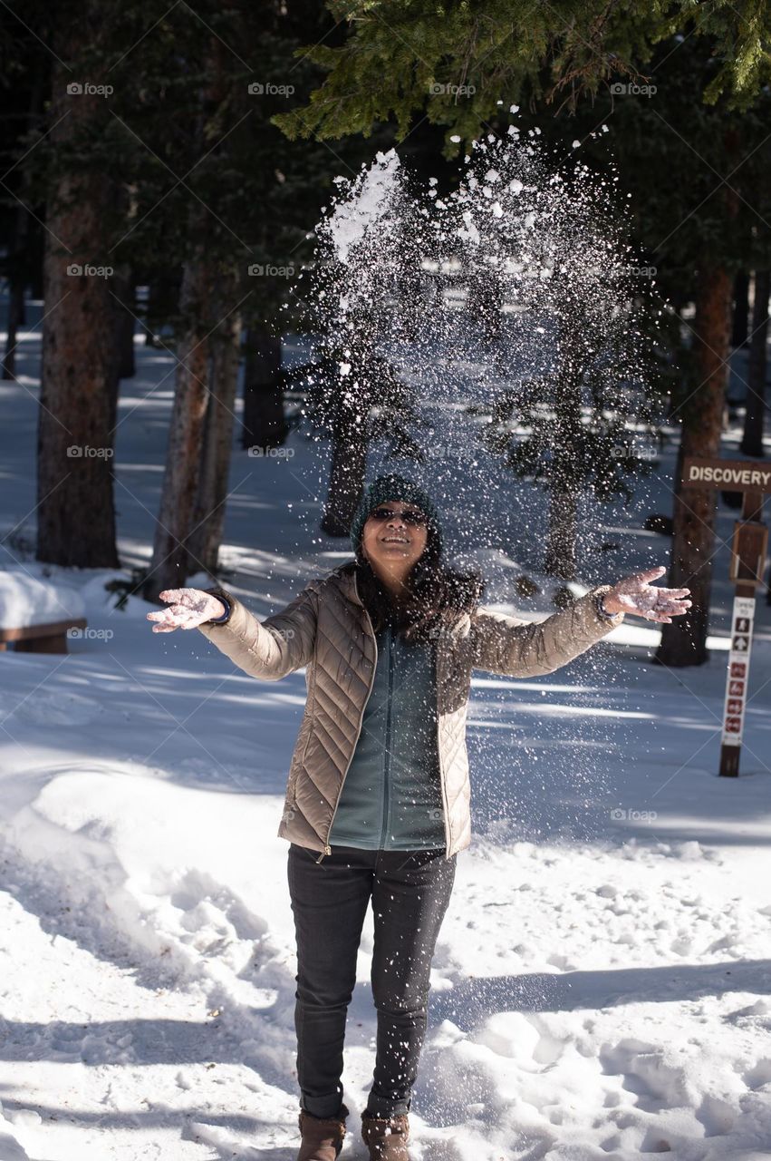 Woman enjoying the fresh fallen snow in winter 