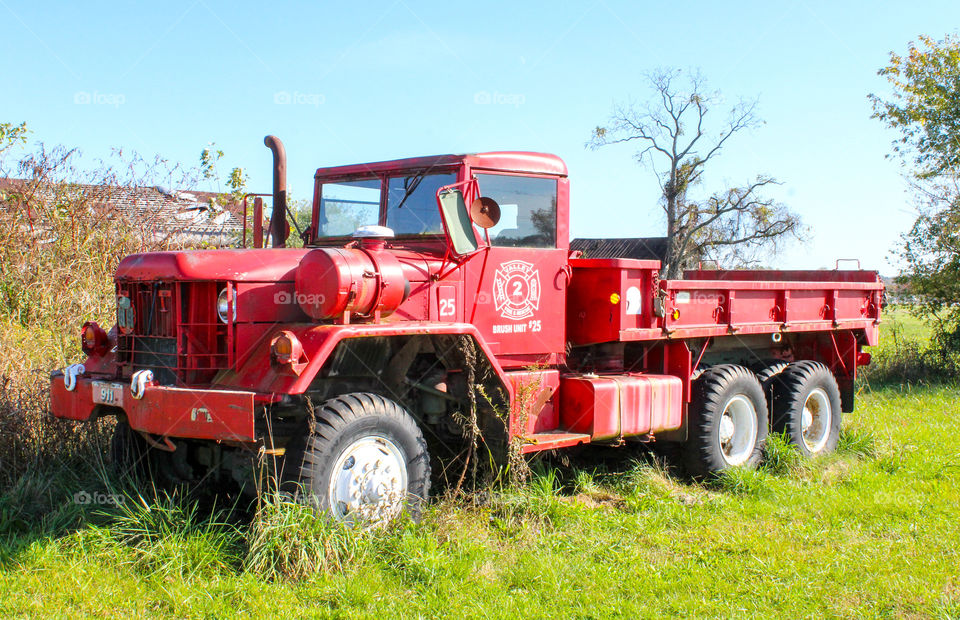 Old red antique fire truck on a farm
