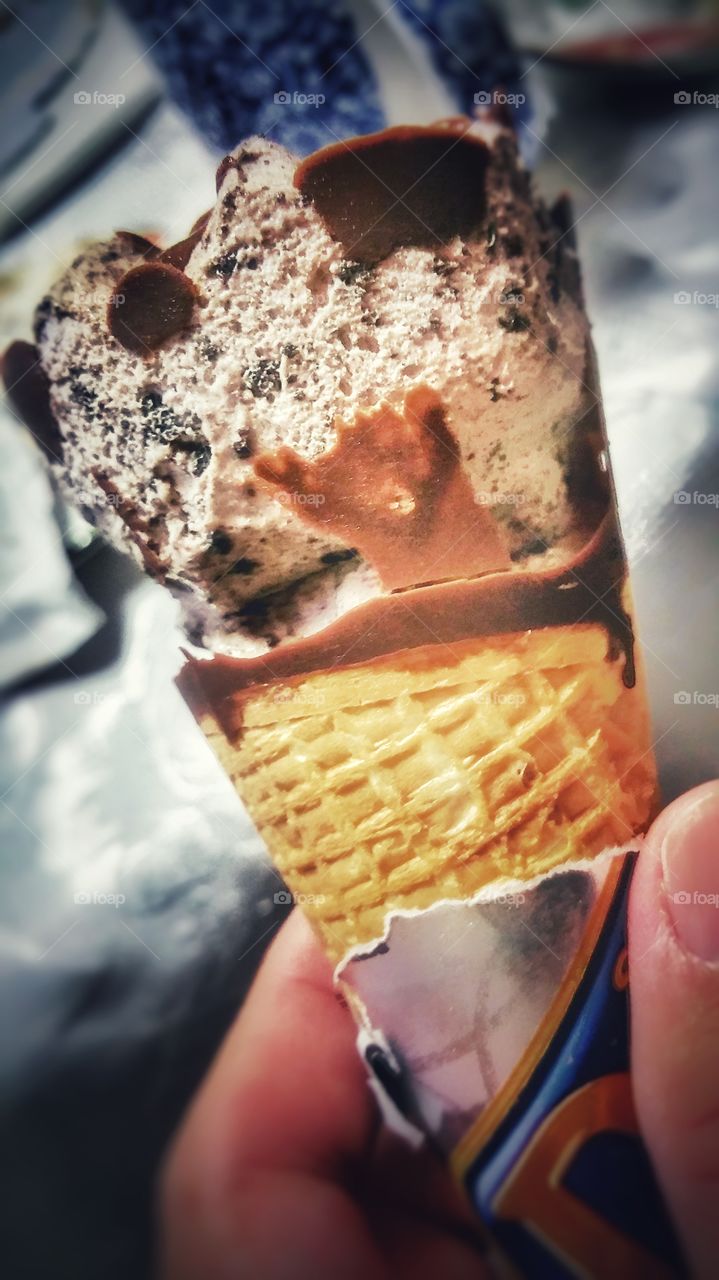 Choc chip ice cream in a cone format. A delicious and refreshing summer treat.