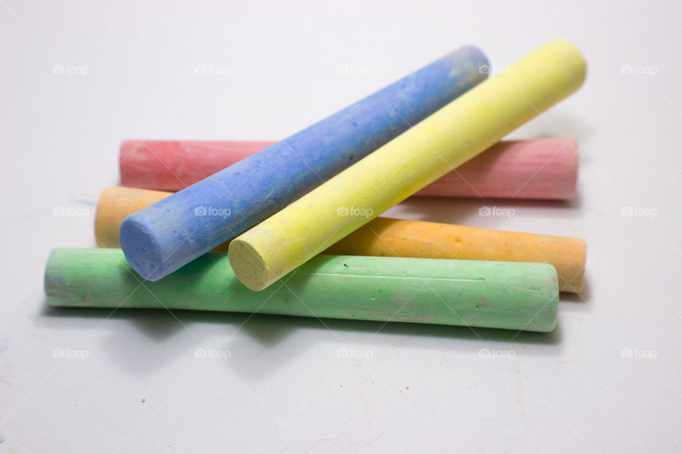five colors of chalk stacked