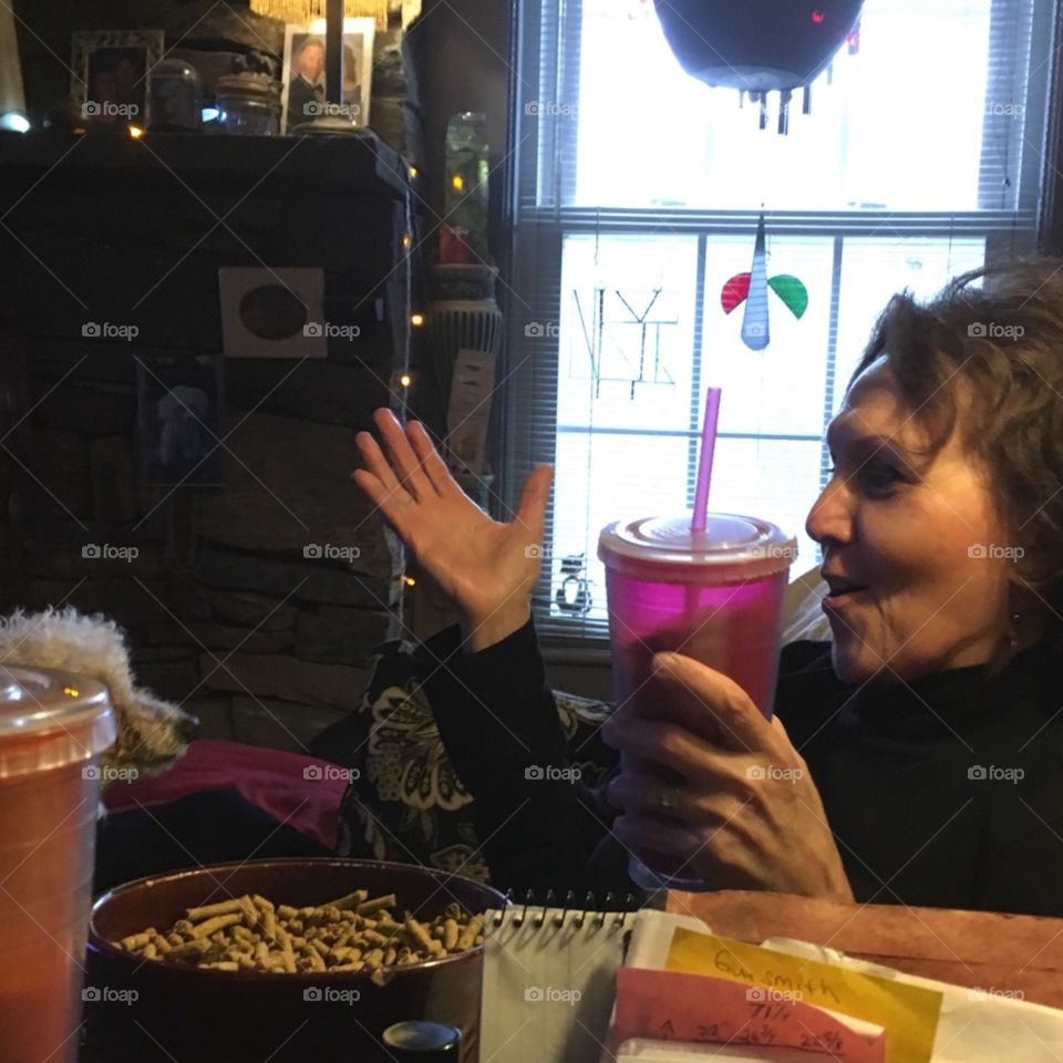 Facial expression, talking with hands, drinking iced coffee. Dog is watching!