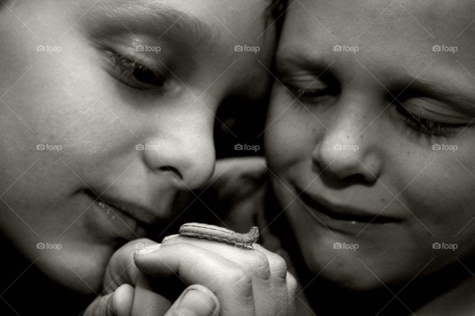 Caterpillars and Boys. Brothers look at a caterpillar 